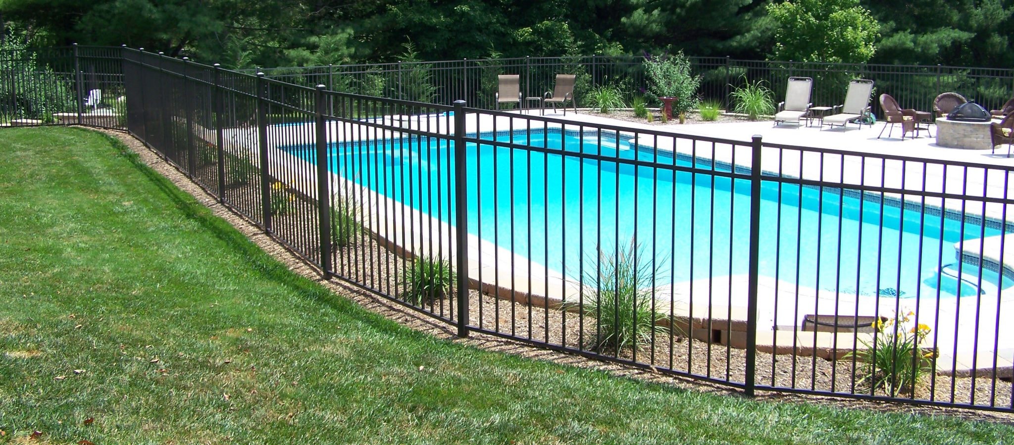 Ornamental aluminum pool fence installed around a residential pool